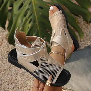 Close-up detail of women's golden mesh flat sandals featuring a breathable hollow out design.
