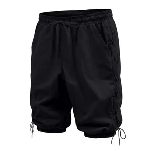 Detailed view of men's black linen cropped pants with side lacing and drawstring