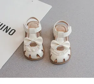 Vista detallada de sandalias blanco roto para niñas con lazo y detalles de encaje
