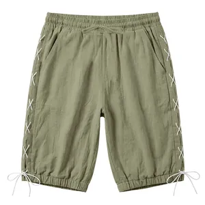 Men's olive green linen capri shorts featuring stylish white side lace-up detailing