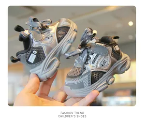 Detailed view of breathable mesh baby sneakers with non-slip soft soles and silver accents