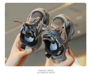 Macro detail of breathable grey mesh children's sneakers featuring thick soft soles
