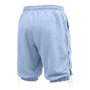 Back view of light blue linen 3/4 pants featuring side lace-up and pocket details