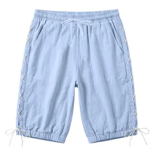 Light blue linen cropped shorts with lace-up side details and adjustable drawstring waist