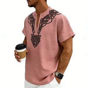 Detail of men's pink slub linen shirt with black rune print and V-neck design.