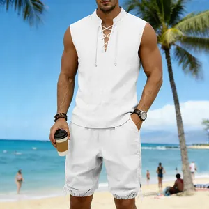 Detail view of men's white linen sleeveless top and shorts set on a sunny beach background