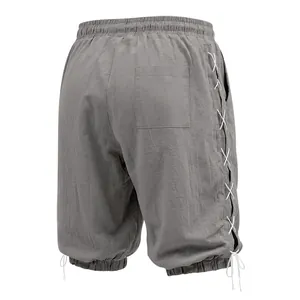 Rear view of grey linen 3/4 length pants featuring side lace-up details.