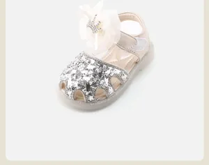 Elegant sparkly silver sequin baby girl sandals with large white chiffon bow ornament