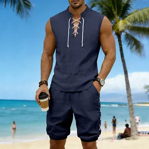 Navy blue men's linen-blend two-piece set featuring lace-up sleeveless top and shorts at the beach.