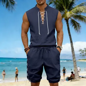 Detailed shot of a men's navy sleeveless linen lace-up top and matching shorts set at beach