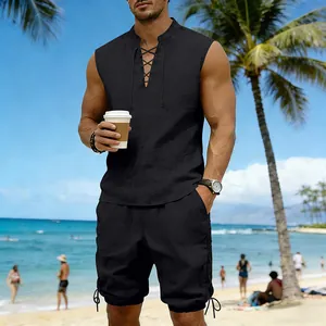 Man wearing a black linen sleeveless set with drawstring details on a tropical beach