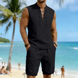Full view of men's sleeveless black linen set on model with beach vacation background