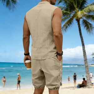 Back view of men's sleeveless khaki linen set with drawstring shorts on a sunny beach