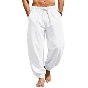 Close-up of men's loose white linen jogger pants for summer beach casual wear