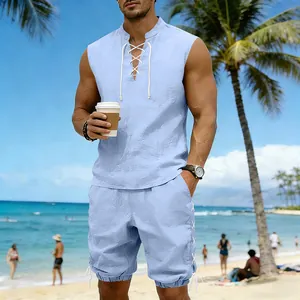 Men's light blue sleeveless linen set with drawstring shorts on a sunny tropical beach