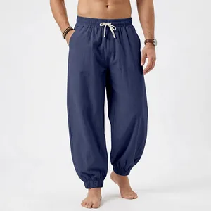 Detailed macro shot of men's loose navy blue linen joggers featuring drawstring elastic waist