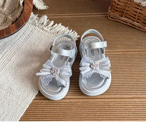 Vue détaillée de sandales argentées pour filles avec nœud en dentelle