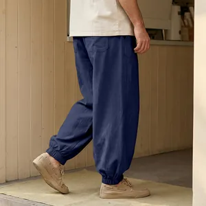 Detail view of men's navy linen harem pants featuring elastic cuffs and a comfortable loose fit.