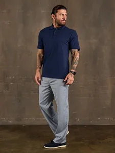 Detailed view of navy blue polo shirt with grey trousers for business casual look
