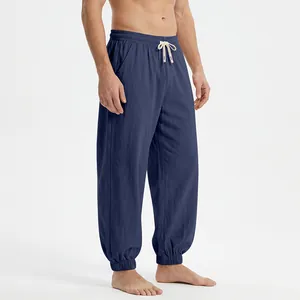 Detail of navy blue men's loose linen joggers with elasticated drawstring waist