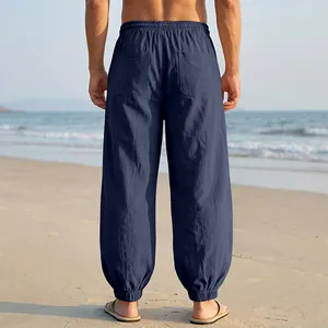 Detailed back view of men's loose navy blue linen beach joggers with elastic cuffs