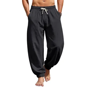 Front view of men's loose black linen joggers with drawstring waist on model