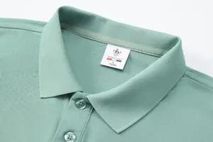 Macro view of mint green polo shirt collar showing breathable fabric texture and neck label