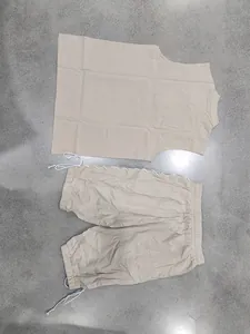 Men's beige linen two-piece set with sleeveless stand-collar top and drawstring shorts