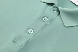 Detailed macro view of mint green ice silk polo shirt collar and button placket texture