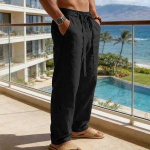 Dettaglio pantaloni in lino nero traspiranti con coulisse uomo su balcone spiaggia