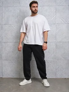 Men's relaxed fit straight-leg black jeans paired with a casual white t-shirt and sneakers