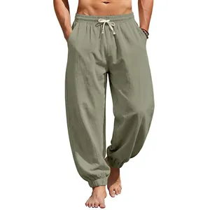 Detail of men's loose linen jogger pants in olive green with drawstring waist