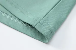 Close-up of the stitching and breathable ice silk fabric on a green men's polo shirt.