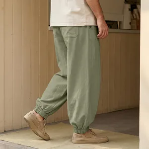 Detail view of olive green men's linen casual joggers with comfortable elastic cuffs