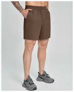 Detailed view of brown men's athletic shorts with elastic waistband and pockets