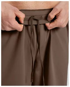 Detail of men's brown quick-dry sports shorts waistband with adjustable drawstring
