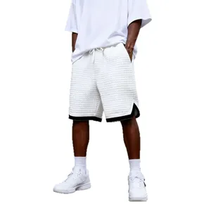 Men's white quilted casual shorts with loose straight-leg fit and black trim hem