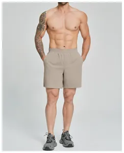 Close-up detail of men's tan elastic quick-drying fitness shorts for outdoor sports