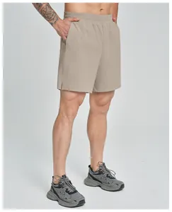 Professional detail view of khaki men's athletic quick-dry shorts worn by a model.