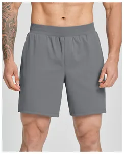Detail view of premium grey quick-dry men's athletic shorts on a fitness model