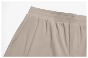 Close-up of waistband and pocket detail on beige men's quick-dry sports shorts