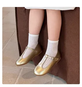 Classic gold T-strap leather shoes for girls styled with white lace socks for a vintage look