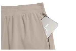 Close-up of men's quick-dry sports shorts pocket showing elastic waist and large side pocket.