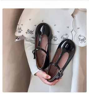 Detailed close-up of girls' black patent leather T-strap Mary Jane princess shoes