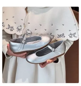 Close-up of elegant silver Mary Jane shoes for girls with a shiny metallic finish