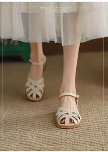 Close-up of French retro beige woven sandals with hollow closed toe and block heel.