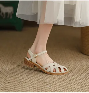 Detailed view of cream French vintage woven sandals with closed toe and low chunky heel