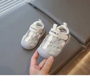 Close-up view of breathable mesh baby walking shoes with soft rubber soles in grey