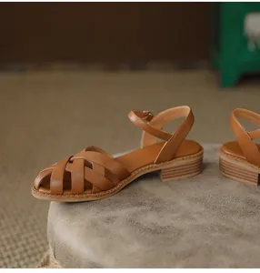 Brown French retro woven sandals with side view showing block heel and soft leather