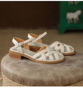 Detailed view of white French retro woven leather sandals with closed toe design.